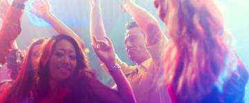 Photo of people dancing in a nightclub.