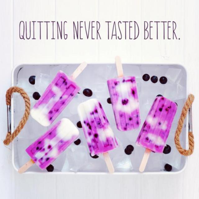 Image is of purple popsicles on a tray, surrounded by blueberries. Captioned, "Quitting never tasted better."